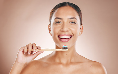 Image showing Woman, portrait or brushing teeth in grooming, dental hygiene or healthcare wellness on pink studio background. Smile, happy or beauty model and toothbrush, toothpaste cleaning or eco friendly bamboo