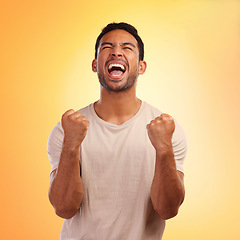 Image showing Winner, screaming man and celebration in studio isolated on a yellow background. Winning, wow and happy young male fist pump for celebrating goals, targets achievement or victory, success or lottery.