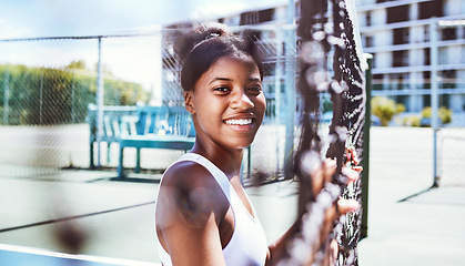 Image showing Fitness, fence or portrait of black woman on a tennis court relaxing on training, exercise or workout break in summer. Happy, sports athlete or healthy African girl ready to play a fun match or game