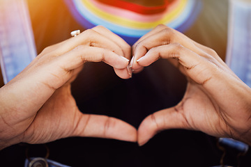 Image showing LGBTQ, pride and hands with a heart sign for love, equality and solidarity of a gay woman. Rainbow, freedom and closeup of lesbian female with a hand symbol at a gay pride celebration festival.