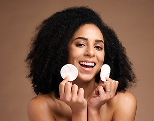 Image showing Face portrait, skincare and black woman with cotton in studio isolated on a brown background. Wellness, cosmetics and happy female model holding facial pad or product for cleaning makeup for hygiene.