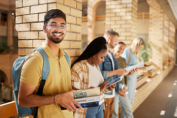 Image showing University, hallway and portrait of Indian man and students standing in row together with books at business school. Friends, education and future, happy man in study group on campus in lobby for exam