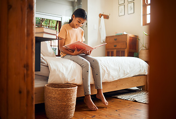 Image showing Happy child reading on bed for home learning, language education and creative development in her bedroom. Smart, intelligent and Indian girl kid with English books for fun story and holiday activity