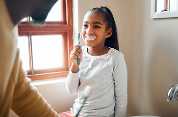 Image showing Daughter, father and brushing teeth in a bathroom for hygiene, grooming and bonding. Oral care, girl and parent for morning cleaning while having fun with black family who laugh and smile at home