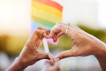 Image showing LGBTQ, pride flag and hands with a heart sign for love, equality and solidarity of a gay couple. Rainbow, freedom and closeup of lesbian women with a hand symbol at a gay pride celebration festival.