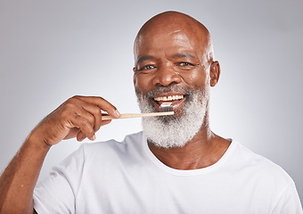 Image showing Brushing teeth, studio portrait and black man with toothbrush for mature dental wellness, healthy lifestyle or cleaning aesthetic in Nigeria. Happy face, male model and oral mouth care of fresh smile