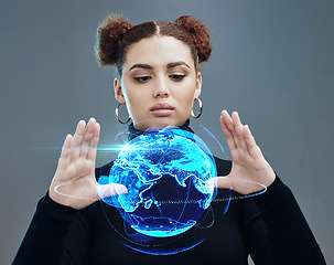 Image showing Globe hologram, futuristic tech and woman, technology innovation with future, ai and cyberspace against studio background. World, network and digital with metaverse and young girl face, 3d and matrix