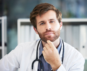 Image showing Portrait, thinking and healthcare with a doctor man sitting in his office of a hospital for consulting or treatment. Face, idea and medical with a male medicine professional in a clinic for care