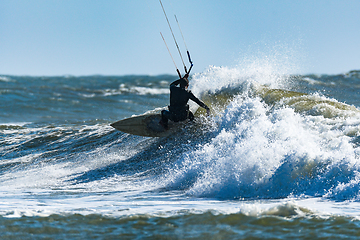 Image showing Kitesurfer riding ocean waves