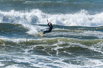 Image showing Kitesurfer riding ocean waves