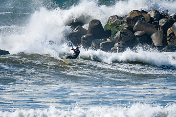 Image showing Kitesurfer riding ocean waves