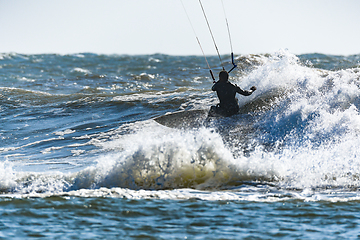 Image showing Kitesurfer riding ocean waves