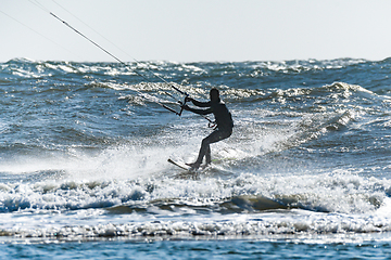 Image showing Kitesurfer riding ocean waves