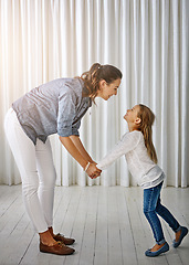 Image showing Happy, family and mom with girl at home holding hands to show love, care and happiness. Lens flare, mother and kid together having fun in a house laughing, playing and holding hand with parent