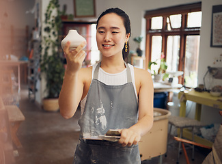 Image showing Creative, art and woman in workshop with clay pot, ceramics and pottery with creativity and pride in work. Happy artist with texture, sculpting and creation in hand with clipboard for product check