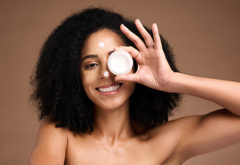 Image showing Face, product and skincare with a model black woman in studio on a brown background for skin treatment. Portrait, container and beauty with an attractive young female posing to promote antiaging care