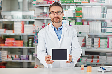 Image showing Pharmacist man, shop and portrait with tablet screen, focus and focus for marketing, medication or sales. Medical professional, pharma expert and mobile digital tech in pharmacy for wellness with app