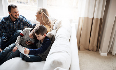 Image showing Family, sofa and boy siblings with tablet, mom and dad in happy conversation in home living room. Happy family together, couch and kids with mobile touchscreen tech for learning, gaming or bonding