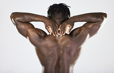 Image showing Back, body and muscular with a model black man posing in studio on a gray background for fitness or exercise. Muscle, health and wellness with a strong male athlete posing or flexing for power