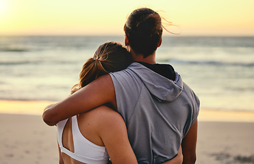 Image showing Hug, fitness and back of couple at the beach for sunset training, exercise and workout with a view. Peace, gratitude and runner man and woman hugging with affection after cardio at the ocean