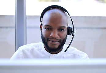 Image showing Black man, face and headset in call center, contact us with CRM and phone call with client and focus. Communication, customer service with telemarketing and tech support, businessman on help desk