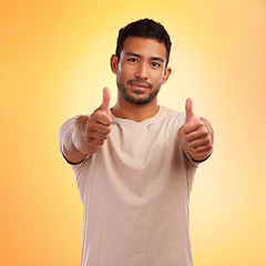 Image showing Portrait, hands and man with thumbs up in studio isolated on a yellow background. Face, fashion and stylish, trendy or cool male with thumbsup for support, thank you or like, emoji or ok hand gesture