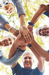 Image showing Senior hands, together and support with solidarity outdoor and group diversity with team building in nature. Trust, respect and mission with mature community, hand stack low angle and collaboration.