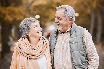 Image showing Senior couple, love and health while walking outdoor for exercise, happiness and care at a park in nature for wellness. Old man and woman together in a healthy marriage during retirement with freedom