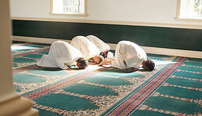 Image showing Muslim, prayer and mosque with a holy man group praying together for fajr, dhuhr or asr, otherwise maghrib or ishaa. Salah, worship and pray with islamic friends at ramadan for religion in sun rays