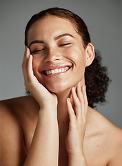 Image showing Face, beauty and skincare with a model black woman in studio on a gray background to promote natural care. Facial, wellness and makeup with an attractive young female happy with her skin product