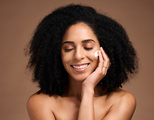 Image showing Skincare, cream and black woman with smile for beauty, cosmetics and facial health promotion of product in studio. Happy African model with skin care, dermatology or sunscreen application on her face