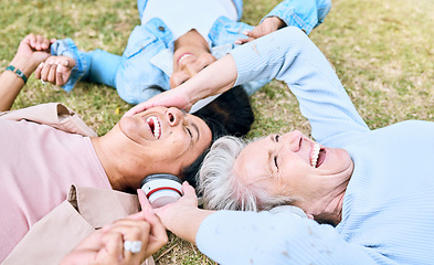 Image showing Seniors, laughing or people and music headphones in silent disco, retirement friends fun or bonding community wellness. Smile, happy or elderly women lying on nature park grass and listening to radio