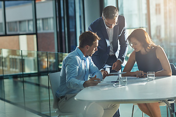 Image showing Men, woman and tablet at business meeting in office planning, goals or mission at desk with strategy. Teamwork, touchscreen or leadership for vision, collaboration and coaching in financial company