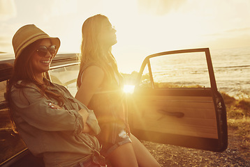 Image showing Friends at sunset, women and car beach with travel and adventure on road trip, outdoor with nature and sea holiday. Happy people, freedom and gen z youth on summer vacation, happiness with lens flare