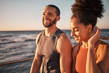 Image showing Black couple, fitness and walking at the beach in conversation or talk together with smile for the outdoors. Happy man and woman enjoying fun sunset walk smiling for holiday break by the ocean coast