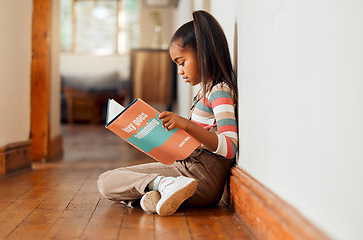 Image showing Little girl, book and reading on wooden floor for story time, learning or education relaxing at home with smile. Happy child smiling, sitting and enjoying books, read or stories at the house indoors