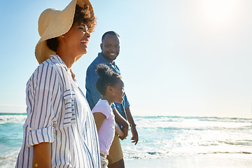 Image showing Family, travel and walking on a beach with a child or kid on vacation at the ocean or sea. Mock up, parents and happy African American daughter relaxing and enjoying trip or holiday and holding hands