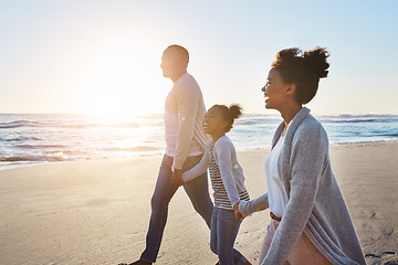 Image showing Black family, sunset and walking on the beach by happy child and parents on vacation or holiday. Sea, ocean and travel with African daughter or kid holding hands together near water