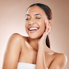 Image showing Skincare, beauty and happiness, woman with smile laughing on studio background at fun spa. Makeup, glamour and wink, luxury skin care with hands on face, natural detox facial massage on happy woman.