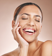 Image showing Skincare, beauty and happiness, woman with eyes closed, smile and laughing on studio background at fun spa. Makeup, glamour and luxury skin care with hand on face, natural detox facial on happy woman