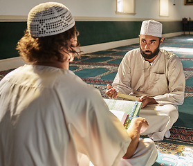 Image showing Quran, muslim and mosque with an imam teaching a student about religion, tradition or culture during eid. Islam, book or worship with a religious teacher and islamic male praying together for ramadan