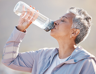 Image showing Fitness, wellness and senior runner drinking water for hydration on outdoor run, marathon training or cardio workout. Sports exercise, bottle and profile of thirsty woman running in Miami Florida USA