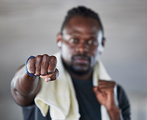 Image showing Fist, boxer and martial arts with black man and fitness, sports and boxing with exercise and hand zoom. Athlete, wellness and MMA fighter with towel, workout and training with sport motivation