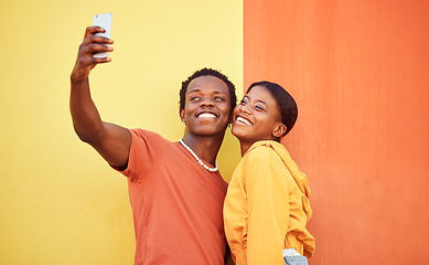 Image showing Gen z, young black couple happy in selfie with smartphone and influencer with post for social media against color wall background. Smile in picture, fashion mockup and tech with man and woman youth