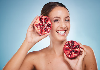 Image showing Face portrait, skincare and woman with pomegranate in studio on a blue background. Organic cosmetics, beauty and female model with product, fruit or food for vitamin c, nutrition and healthy diet.