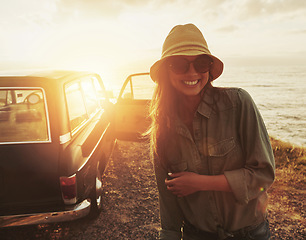 Image showing Woman, road trip and smile for sunset journey, travel or vacation with a view of the ocean in outdoor nature. Happy female traveler smiling in happiness for summer with lens flare for a beach drive