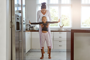 Image showing Home, kitchen and mother play with child bonding, love or holiday celebration together on mothers day. Happy, excited and family support, growth development of mom and girl kid on mothersday in house