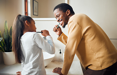 Image showing Oral care, brushing teeth and father with daughter in bathroom for hygiene, grooming and bonding. Dental health, girl and black people cleaning while having fun, playful and smile in their home