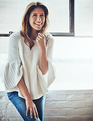 Image showing Woman, laughing or fashion portrait by window in house, home or apartment in cozy, warm or winter clothes. Smile, happy or brunette model in trend, cool or style clothing in relax living room comfort