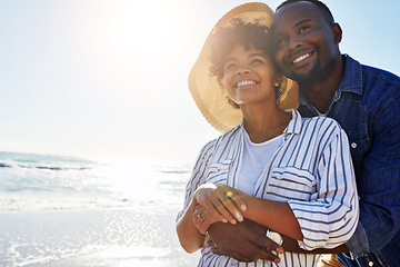 Image showing Beach hug, smile and black couple relax, travel and enjoy outdoor quality time together on Jamaica holiday mockup. Ocean sea water, blue sky flare and freedom peace mock up for happy bonding people